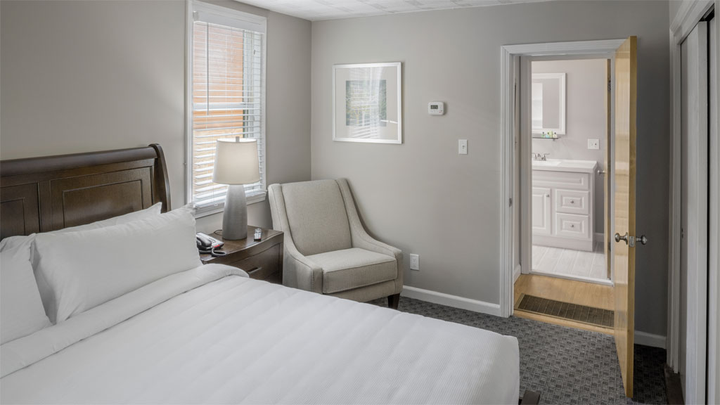 Relax in the comfort of your king bed in the lower floor master bedroom of the cottage